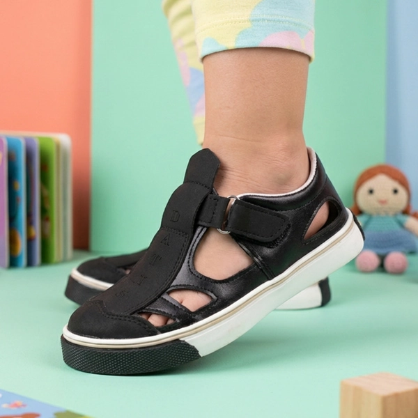 alt: صندل بچگانه داتیس مدل دانیال رنگ مشکی پوشیده شده روی پا، مناسب استفاده روزمره کودک